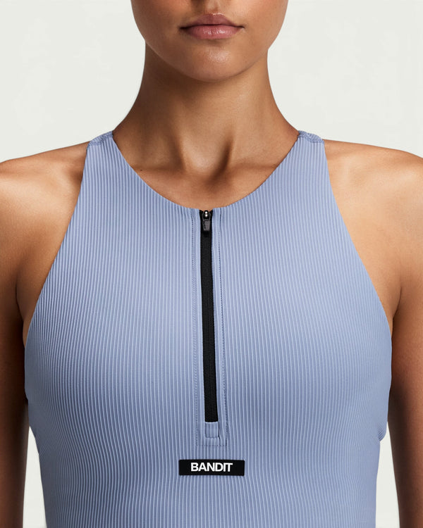 Amateur women's light blue ribbed zip-front race crop top with halter T-back design and built-in bra support