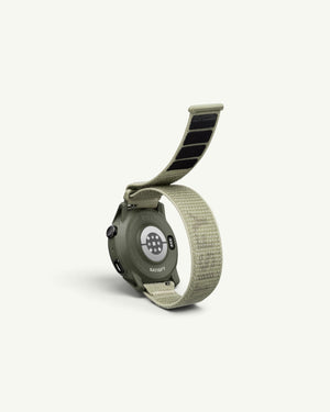 Amateur SATISFY COROS APEX 4 multisport watch in Burnt Olive with nylon band, showing the sensor-equipped case back.
