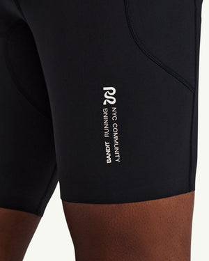 Amateur men's black SoLite compression half tights with white Bandit Running NYC Community logo detail on the leg
