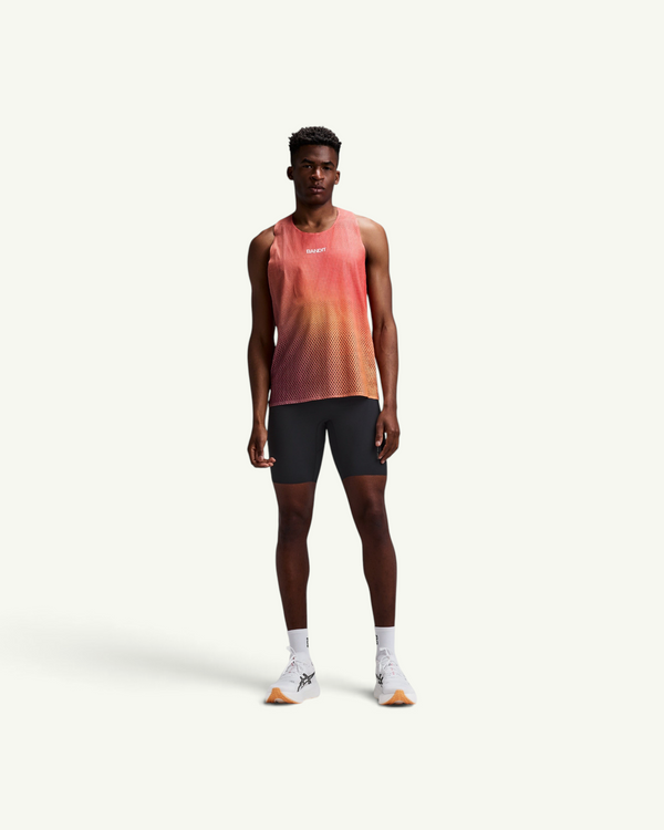 Amateur men's black compression half tights for running, featuring a supportive ribbed build and mesh details.