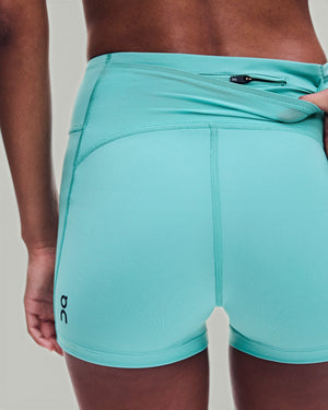 Amateur women's 3-inch performance running shorts in turquoise with a secure back zip pocket and supportive fit.