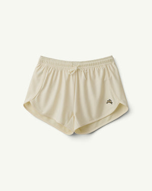 Amateur women's Van Cortlandt racing shorts in cream 2:09 mesh with a drawstring waist and small hare logo embroidery.