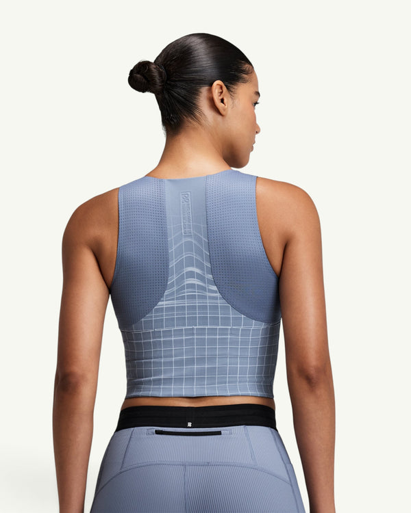 Amateur women's blue Vanisher square neck race crop top with GeoMesh back panel and storage pockets, rear view