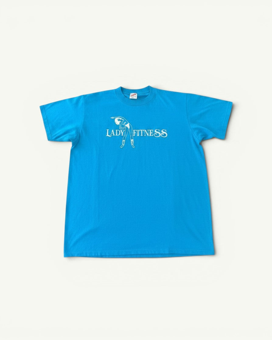 Amateur vintage blue cotton T-shirt featuring a white Lady Fitness graphic print on the chest.