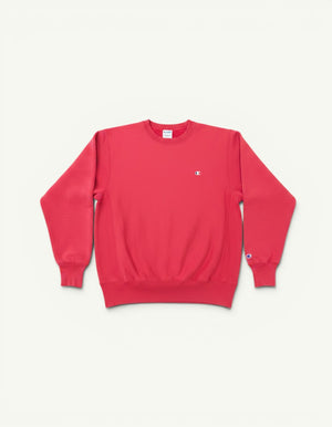 Amateur vintage washed pink Champion crewneck sweatshirt with small embroidered logo on chest and sleeve