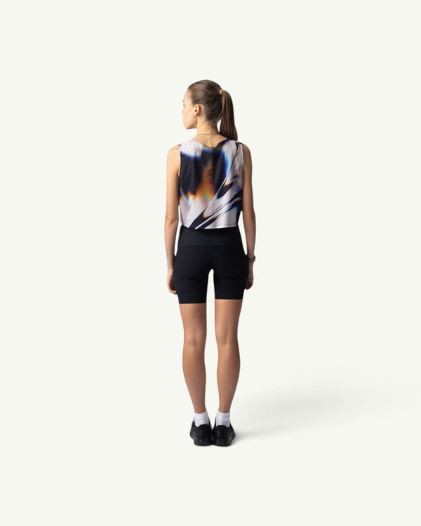 Amateur White Glass crop singlet with abstract print worn by a runner from the back view