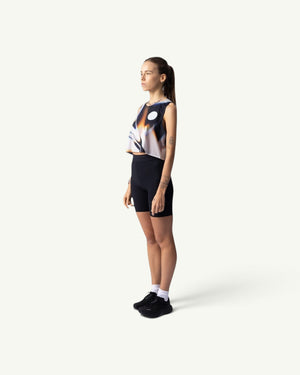 Amateur White Glass crop singlet worn by a female runner in a side profile view, featuring a quick-drying stretch fit.