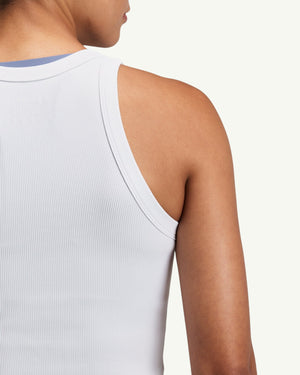 Amateur women's white ribbed performance tank top with a close-fitting design and moisture-wicking fabric.