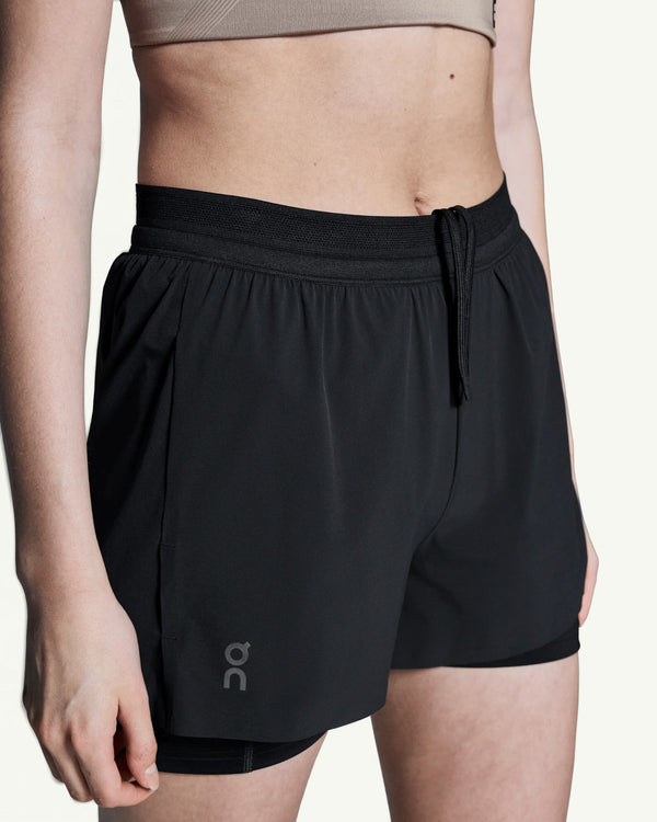 Amateur women's black 3-inch 2-in-1 performance running shorts with supportive inner tights and drawstring waist