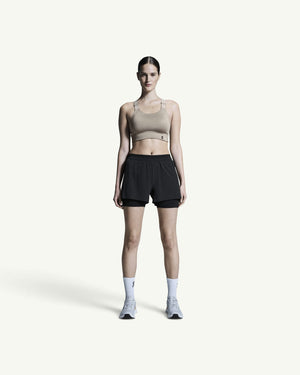 Amateur women's black 3-inch 2-in-1 performance running shorts with supportive inner tights on a model