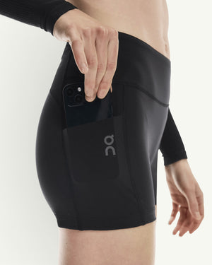 Amateur women's black 3-inch performance running tights featuring a side pocket holding a smartphone