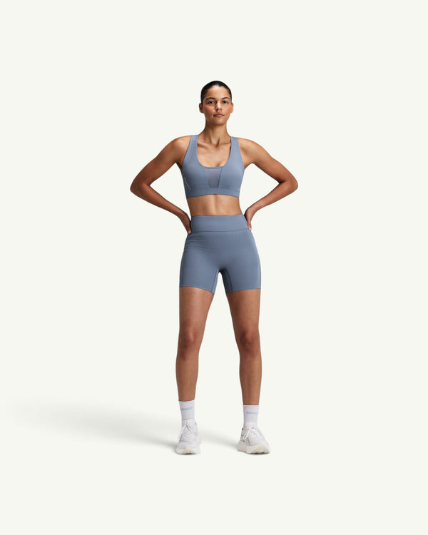 Amateur women's blue high-waist compression shorts with moisture-wicking fabric and secure side pockets