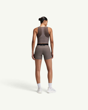 Amateur women's brown square neck race crop top with GeoMesh back panel and storage pockets, back view.