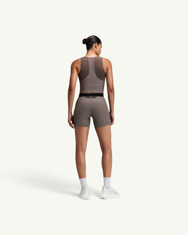 Amateur women's brown square neck race crop top with GeoMesh back panel and storage pockets, back view.