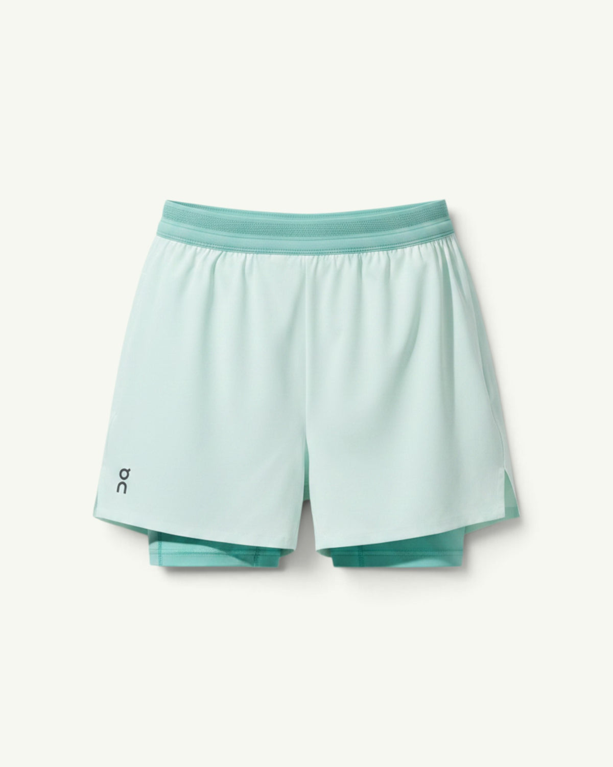 Amateur women's light mint green 3-inch performance 2-in-1 running shorts with supportive inner tights.