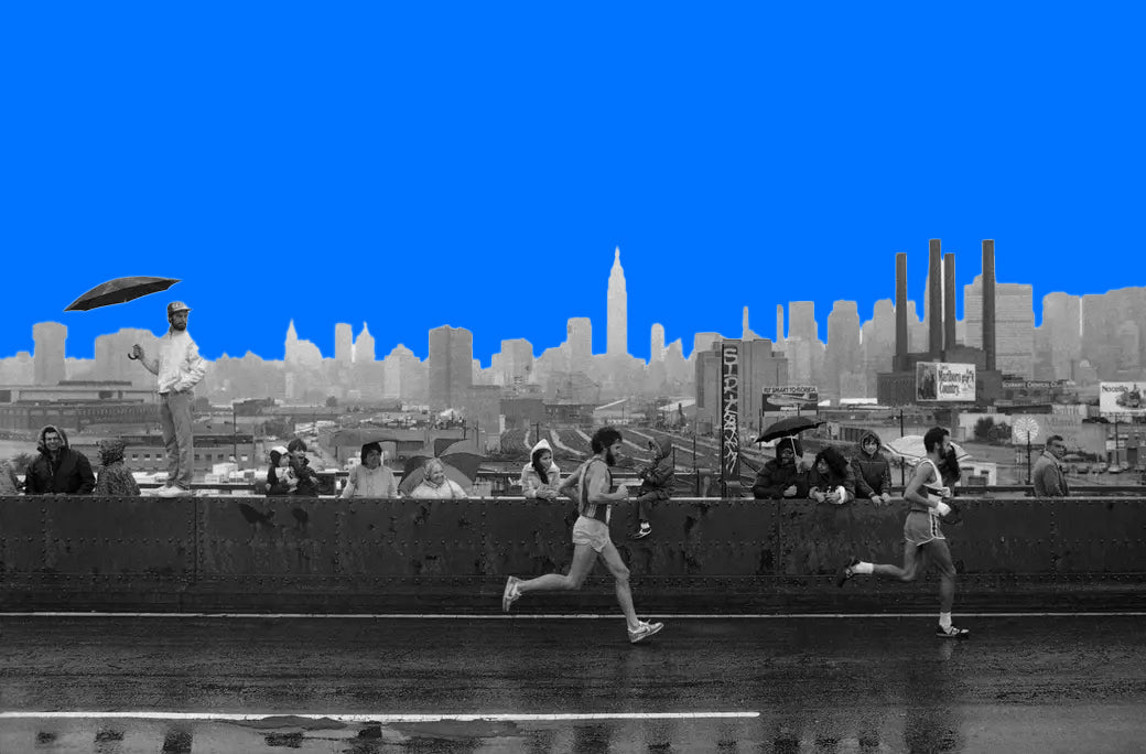 Archive photo of two runners on a bridge with spectators and the Manhattan skyline cut out against a bright blue sky